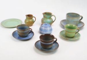 A collection of Prinknash pottery teawares, includes cups, saucers, cream jugs and preserve pot