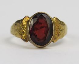 An Antique Precious Yellow Metal and Garnet Ring with chased foliate decoration, 10.7x7.9mm rub over