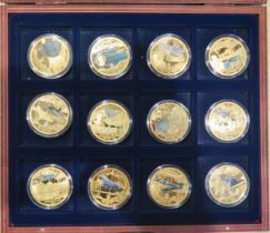 A collection of twelve History of Aviation medallions, contained in a mahogany case.