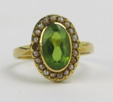 An Antique 18ct Gold, Peridot and Pearl or Cultured Pearl Ring, 14.9x11mm head, rubbed 18CT mark,