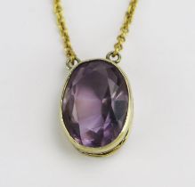 A 9ct Gold and Amethyst Pendant on an integral chain, 14.6x10.8mm oval rub over set stone, 21" (53.