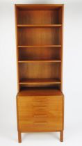 A Troeds Danish Teak Open Bookcase on Four Drawer Chest raised on four legs, stamped to the base,