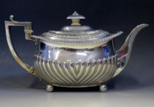 A George III silver teapot, maker's mark worn, London, 1814, of barge-shaped outline, with gadrooned