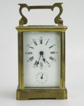 A lacquered brass carriage clock, the 6cm Roman dial with subsidiary alarm dial, the movement with