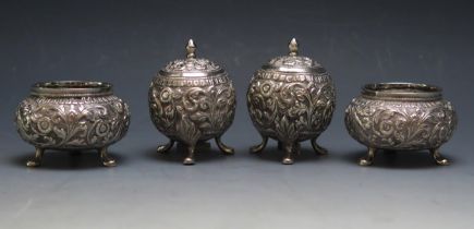 A pair of Burmese silver condiments of circular form, raised on three swept legs, together with a