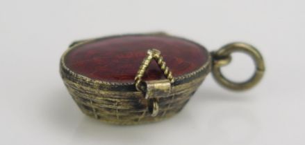 A Continental Silver Gilt and Enamel Baby in a basket charm, 800 mark, 2.1g