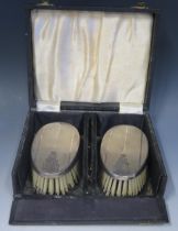 A pair of Elizabeth II silver backed brushes, maker W I Broadway & Co, Birmingham, 1964, contained