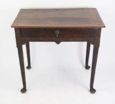 A late 18th century oak side table, the rectangular top with a moulded edge, having a single long