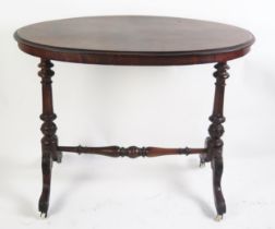 A Victorian occasional table the oval quarter veneered top raised on single column trestle end