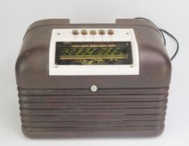 A Bush mains radio contained in a brown Bakelite case, 34cm wide, 23cm high.