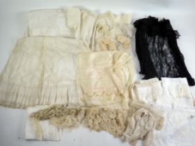 A collection of lace and crochet collars, cut work table cloths, Victorian black lace shawl, lace