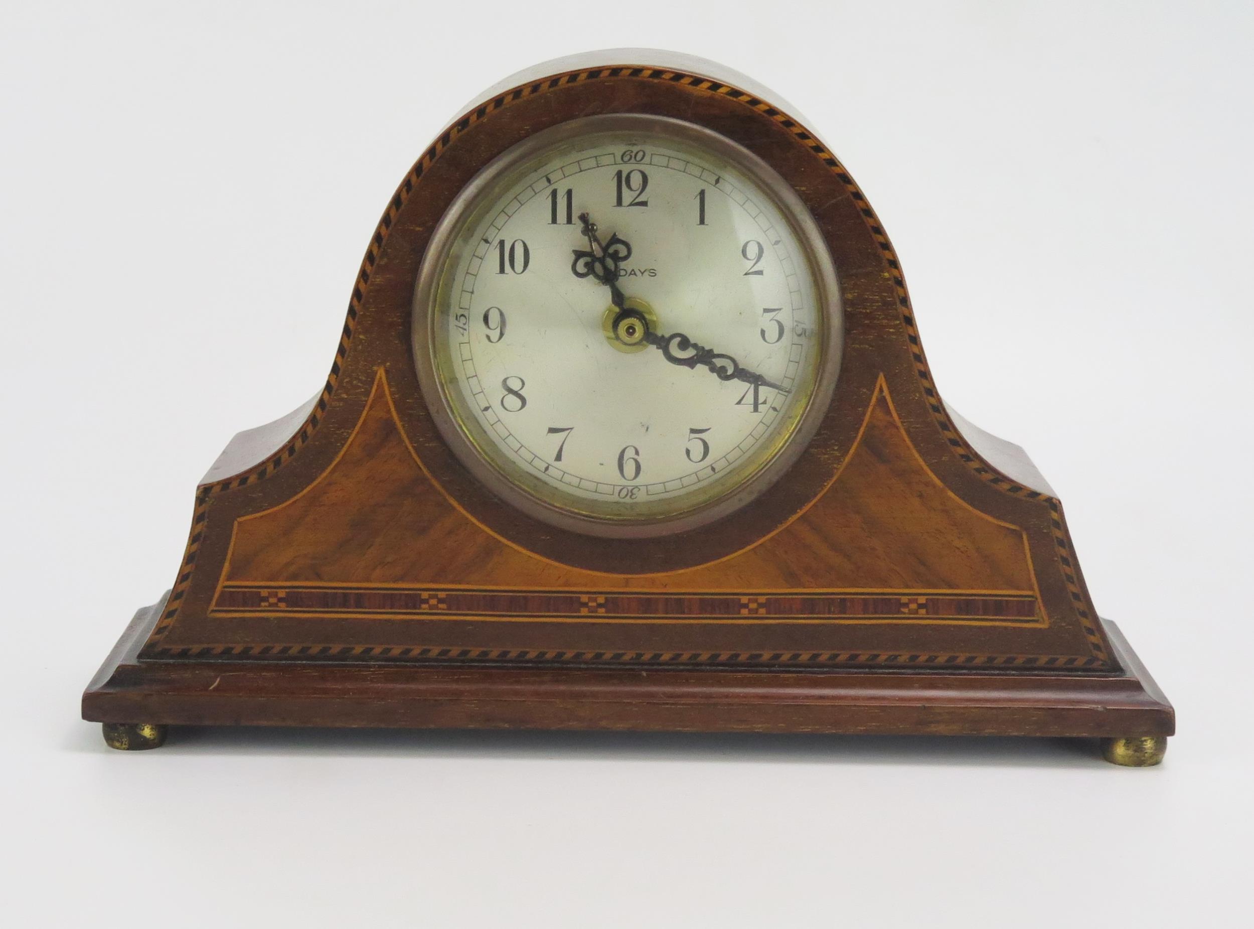 An Edwardian mahogany and chequered strung mantel clock of arched outline with 8cm silvered Arabic