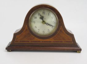 An Edwardian mahogany and chequered strung mantel clock of arched outline with 8cm silvered Arabic