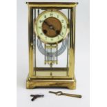A lacquered brass four-glass mantel clock of rectangular outline, the circular movement with 9cm
