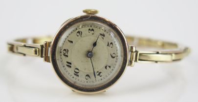 A 9ct Gold Ladies Wristwatch with a Swiss manual wind movement and on a 9ct gold spring loaded