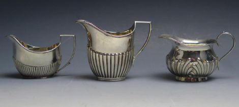 A mixed collection of three silver cream jugs, various makers and dates, total weight of silver