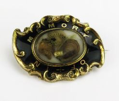 A Victorian Yellow Metal and Enamel Memorial Brooch with a central glazed panel containing a lock of