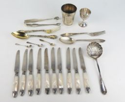 A collection of continental silver wares including beaker, egg cup, sugar tongs assorted flatwares