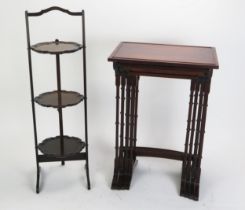 A nest of quartetto mahogany tables, on dual column trestle end supports with swept feet, 50cm wide,