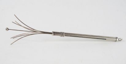 A silver cocktail swizzle stick, stamped 925, with engine turned decoration, 13.5cm extended.