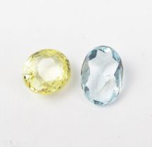 A Yellow Sapphire (c. 8.2x7.2x5.5mm) and a pale blue stone