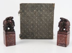 A pair of Chinese carved hardstone seal, of rectangular outline surmounted with figures and an