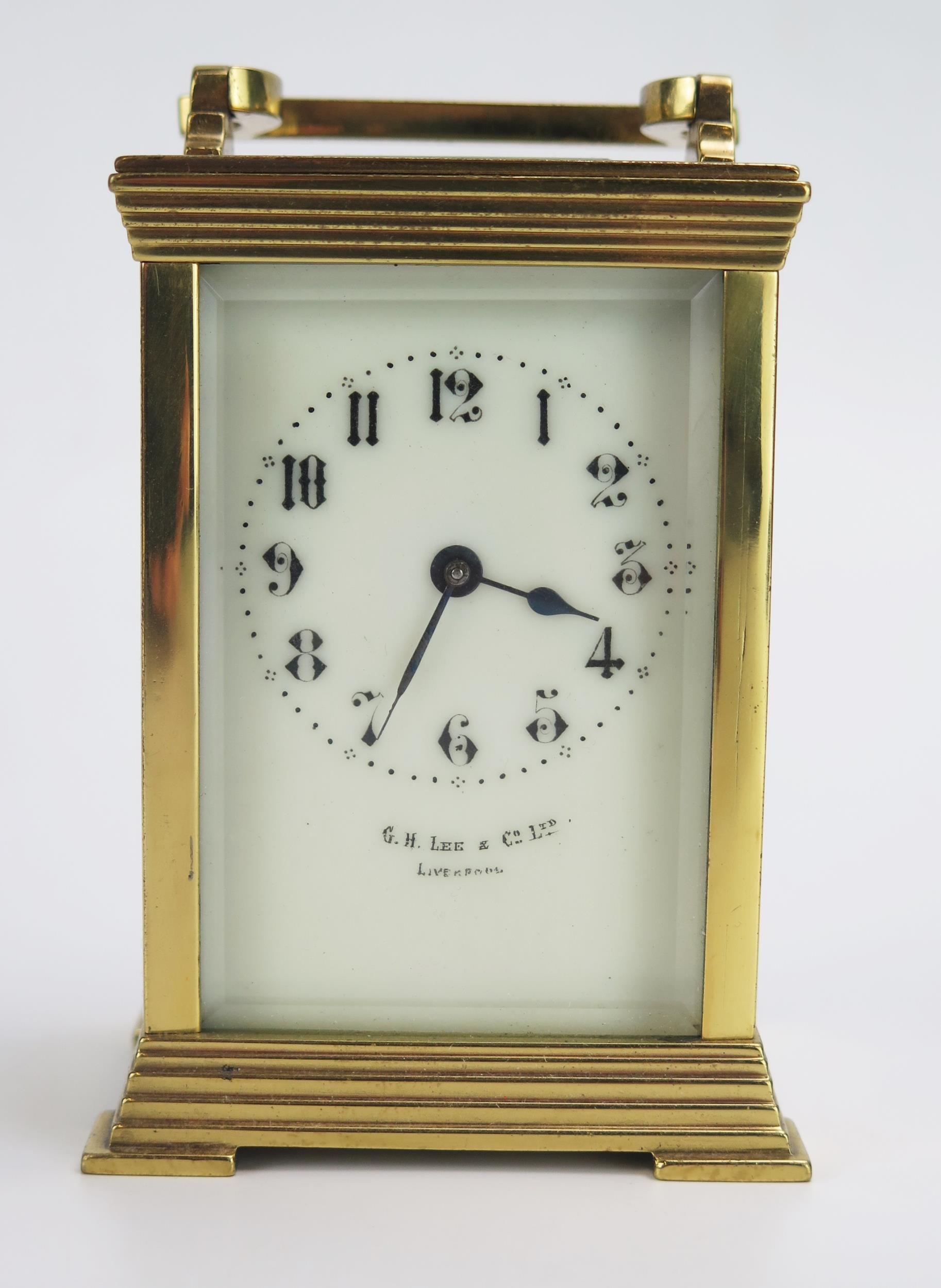 A lacquered brass carriage timepiece, with 6cm ivorine Arabic dial, the movement with lever platform
