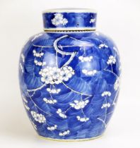 A Kangxi blue and white jar and cover, of ovoid form, with all-over prunus decoration, bears four