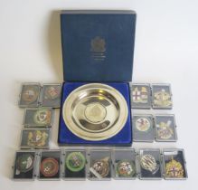 A collection of gilt metal and enamel railway badges, an LSWR horn whistle, Inter City badge,