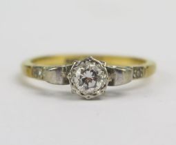 An 18ct Gold and Diamond Solitaire Ring, c. 4.5mm brilliant round cut stone with accent stones to