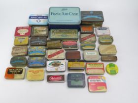 A collection of assorted pastille tins by various companies, a metal First aid tin etc.