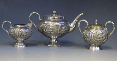 An Indian silver miniature silver three-piece tea service, includes pedestal teapot, cream jug,