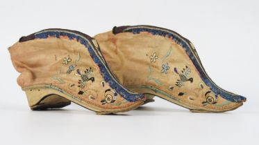 A pair of late 19th century Chinese silk shoes of traditional design decorated with birds to a
