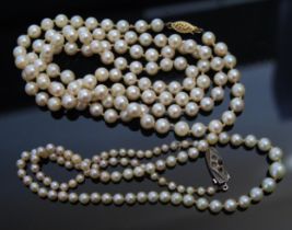 Two Cultured Pearl Necklaces: one with 14KT gold clasp 32.5", 83cm, the other with a silver clasp