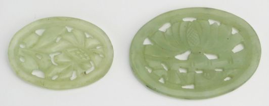 A Chinese carved jade floral medallion of oval outline 6.5cm wide together with a smaller example