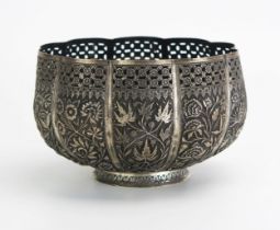 An Indian silver rose bowl, of lobed circular form, with embossed floral decorated panels. raised on