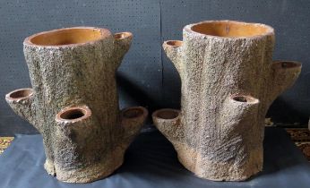 A pair of early 20th century salt glaze 'faux bois' strawberry planters, in the form of tree trunks,