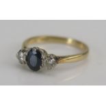 An 18ct Gold, Sapphire and Diamond Three Stone Ring, size J, stamped 18CT, 2.29g