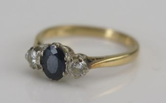 An 18ct Gold, Sapphire and Diamond Three Stone Ring, size J, stamped 18CT, 2.29g