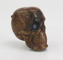 A novelty pressed metal vesta case in the form of a human skull, 4.25cm high.