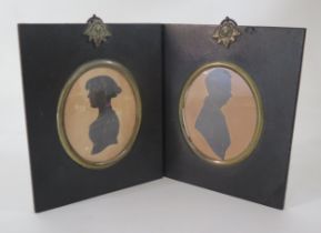 A pair of Regency period silhouettes of a lady and gentleman, heightened in gilt and contained in