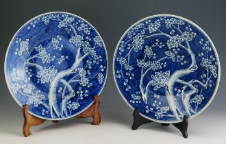 A pair of Qing Chinese blue and white chargers, with all over prunus decoration, 37cm diameter.