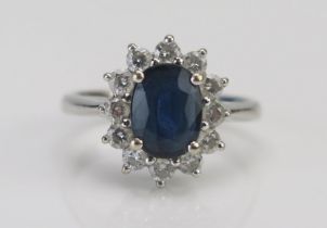 A Modern 18K White Gold, Sapphire and Diamond Cluster Ring, c. 8x6mm principal stone, 13.35x11.9mm