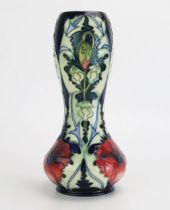 A Moorcroft pottery vase of waisted form with Poppy decoration, 29cm high.