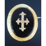 An Antique French 18ct Gold and Onyx Brooch with chased decoration and with a central cross with