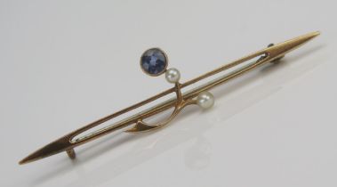 A Sapphire and Seed Pearl or Cultured Seed Pearl Bar Brooch in a precious yellow metal setting, c.