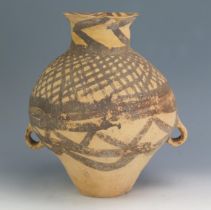 A Chinese Neolithic terracotta jar, of ovoid form, with painted geometric decoration, with loop