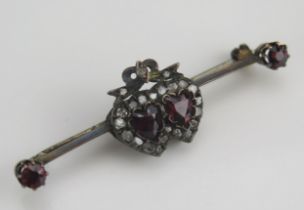 An Antique Garnet and Diamond Chip Conjoined Heart Brooch in a precious yellow metal setting, 5.