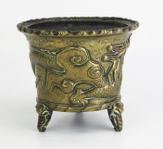 An Antique Chinese cast bronze pot of cylindrical tapering outline, with simulated bamboo rim, the