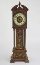 An oak and brass mounted miniature longcase timepiece, of arched outline, with four reeded
